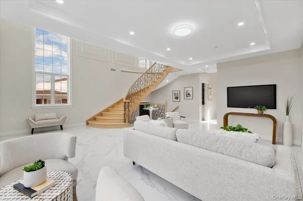 a living room with furniture and a flat screen tv