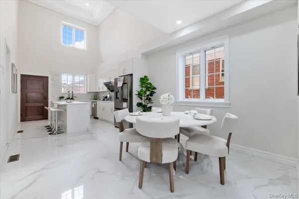 a view of a dining room with furniture and chandelier