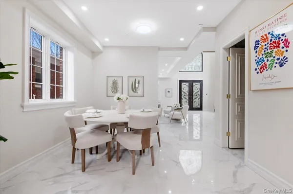 a view of a dining room with furniture and a chandelier