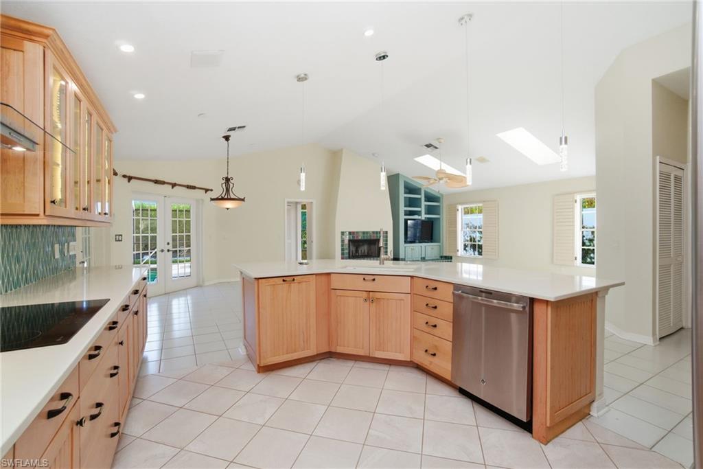 716 Pitch Apple Lane Naples, FL 34108 - Photo 17 of 36 a large kitchen with stainless steel appliances lots of counter space and windows