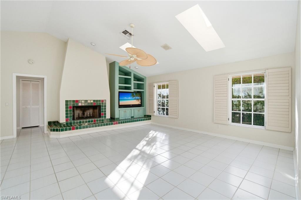 716 Pitch Apple Lane Naples, FL 34108 - Photo 20 of 36 a view of a livingroom with wooden floor and a fireplace