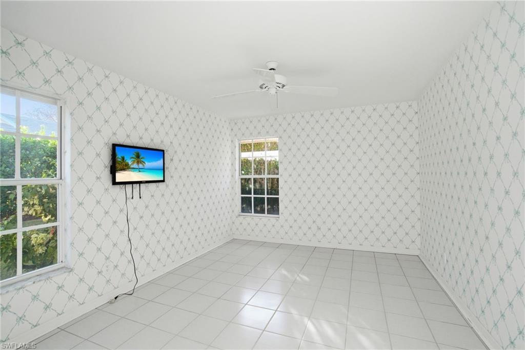 716 Pitch Apple Lane Naples, FL 34108 - Photo 24 of 36 an empty room with windows