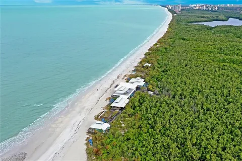 a view of patio with table and chairs under an umbrella