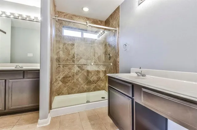 a bathroom with a shower and a sink