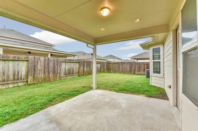a view of a house with a big yard and large tree