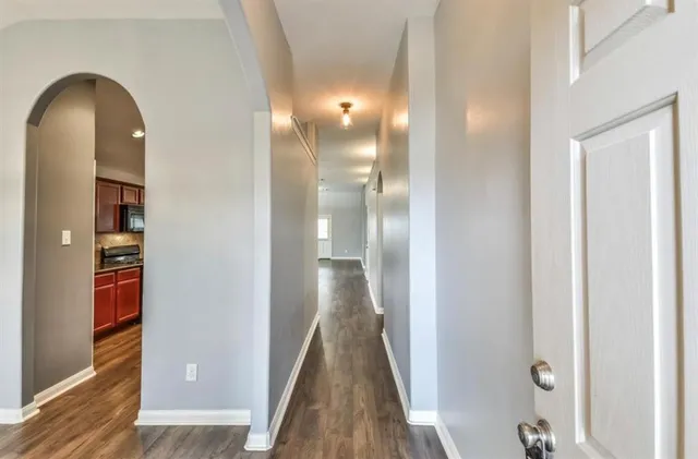 a view of hallway with wooden floor