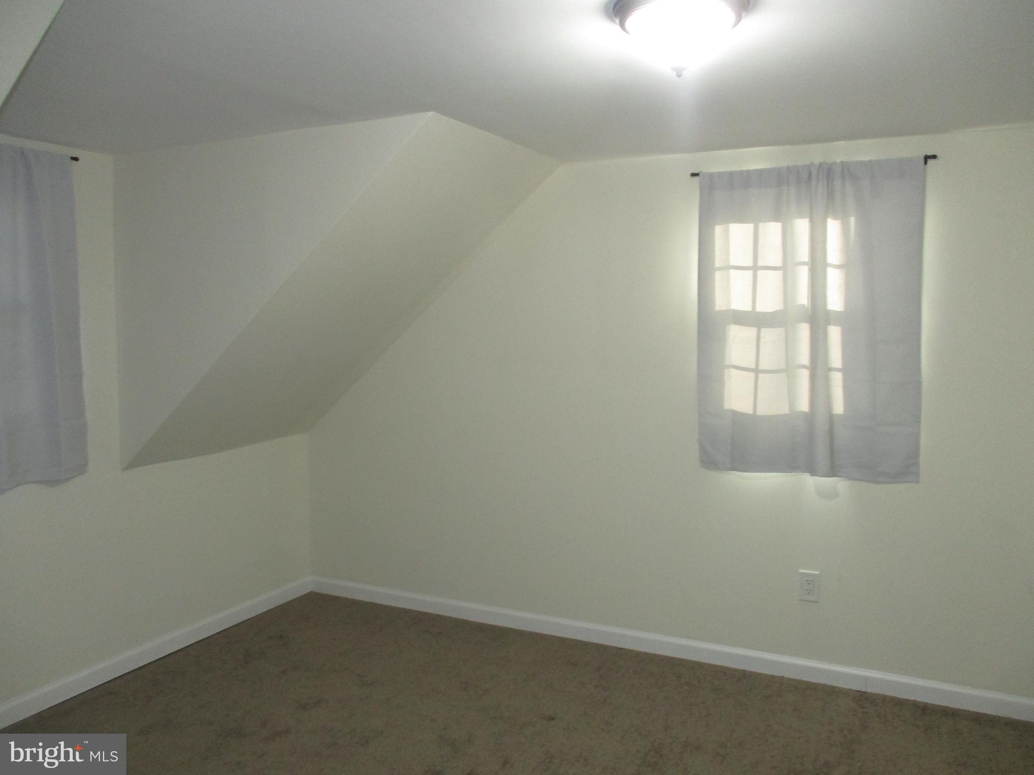 121 Hoover Avenue Hamilton, NJ 08619 - Photo 12 of 12 an empty room with a window