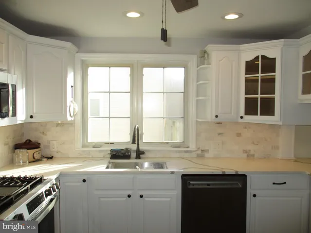 a kitchen that has a sink and a stove