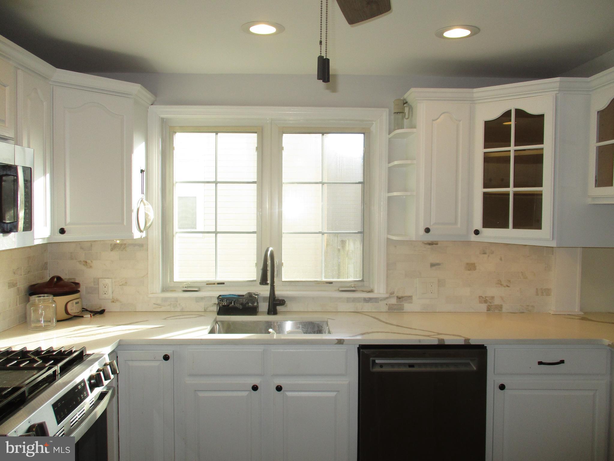 121 Hoover Avenue Hamilton, NJ 08619 - Photo 3 of 12 a kitchen that has a sink and a stove