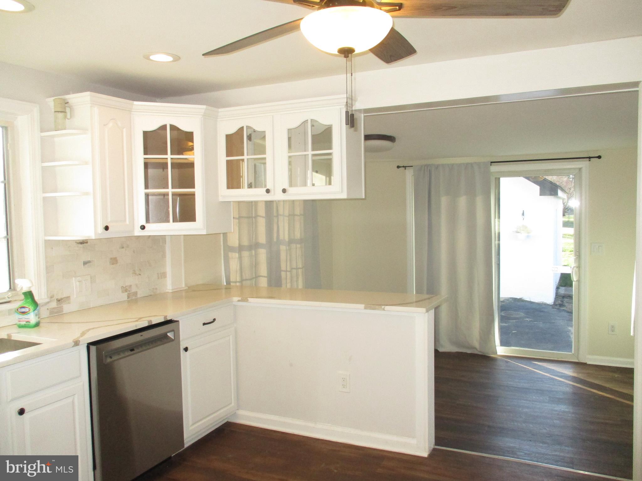 121 Hoover Avenue Hamilton, NJ 08619 - Photo 4 of 12 a kitchen with a refrigerator a sink and cabinets