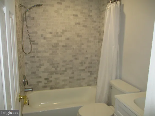 a bathroom with a toilet and a bathtub