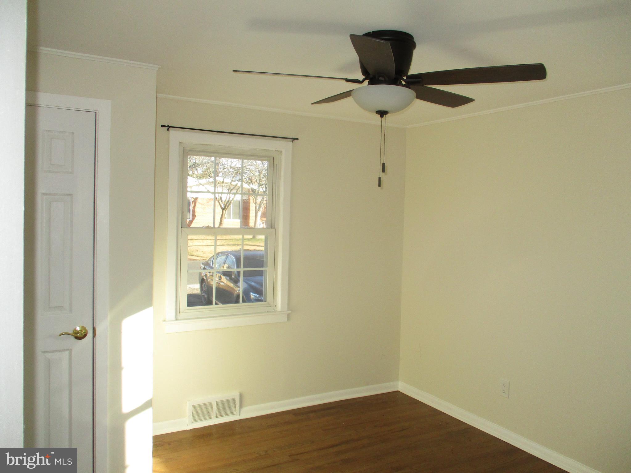 121 Hoover Avenue Hamilton, NJ 08619 - Photo 10 of 12 a view of an empty room with wooden floor and a window