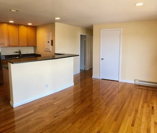 a view of kitchen with wooden floor