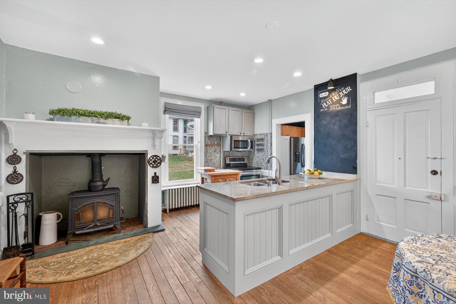 58 East Baltimore Street Taneytown, MD 21787 - Photo 13 of 56 a living room with stainless steel appliances furniture a fireplace and kitchen view
