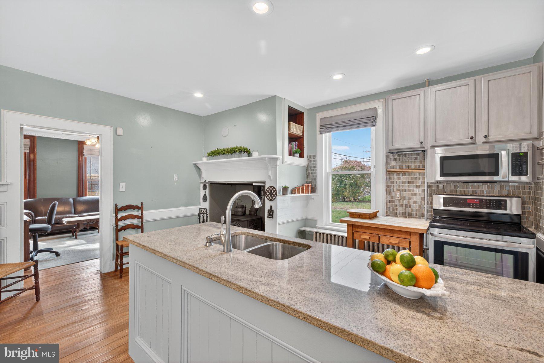 58 East Baltimore Street Taneytown, MD 21787 - Photo 15 of 56 a kitchen with a stove a faucet and chairs