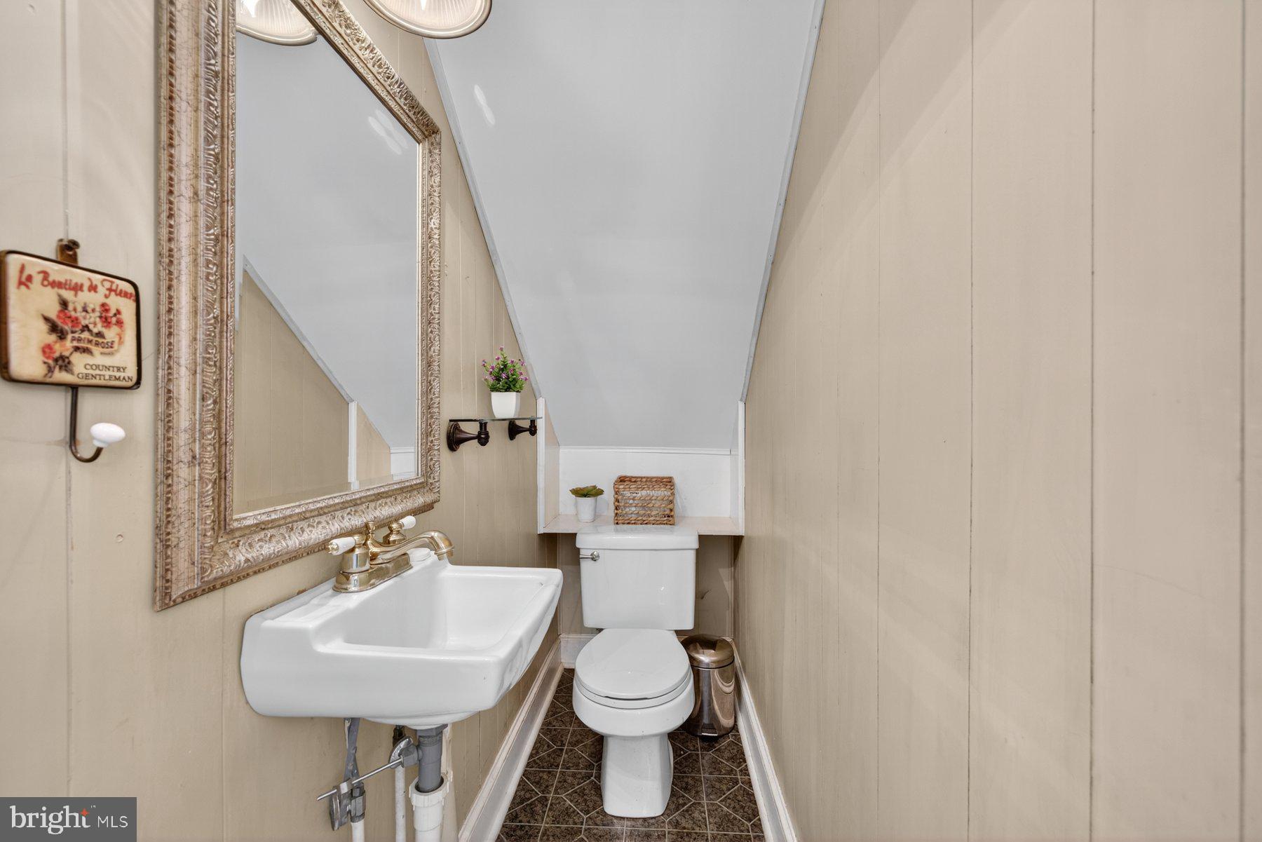 58 East Baltimore Street Taneytown, MD 21787 - Photo 20 of 56 a bathroom with a toilet sink and mirror