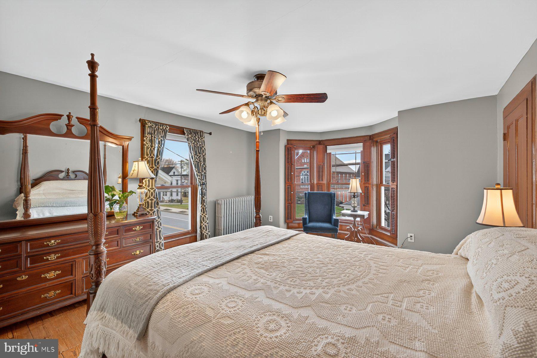 58 East Baltimore Street Taneytown, MD 21787 - Photo 26 of 56 a bedroom with a large bed and a chandelier