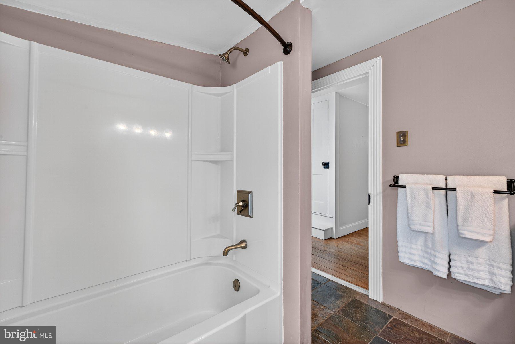 58 East Baltimore Street Taneytown, MD 21787 - Photo 29 of 56 a bathroom with a bathtub and a shower