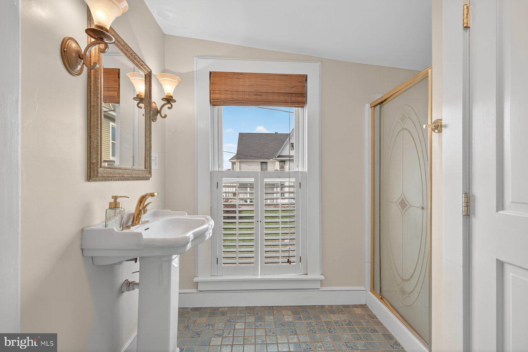 58 East Baltimore Street Taneytown, MD 21787 - Photo 35 of 56 a bathroom with a sink a mirror and a shower