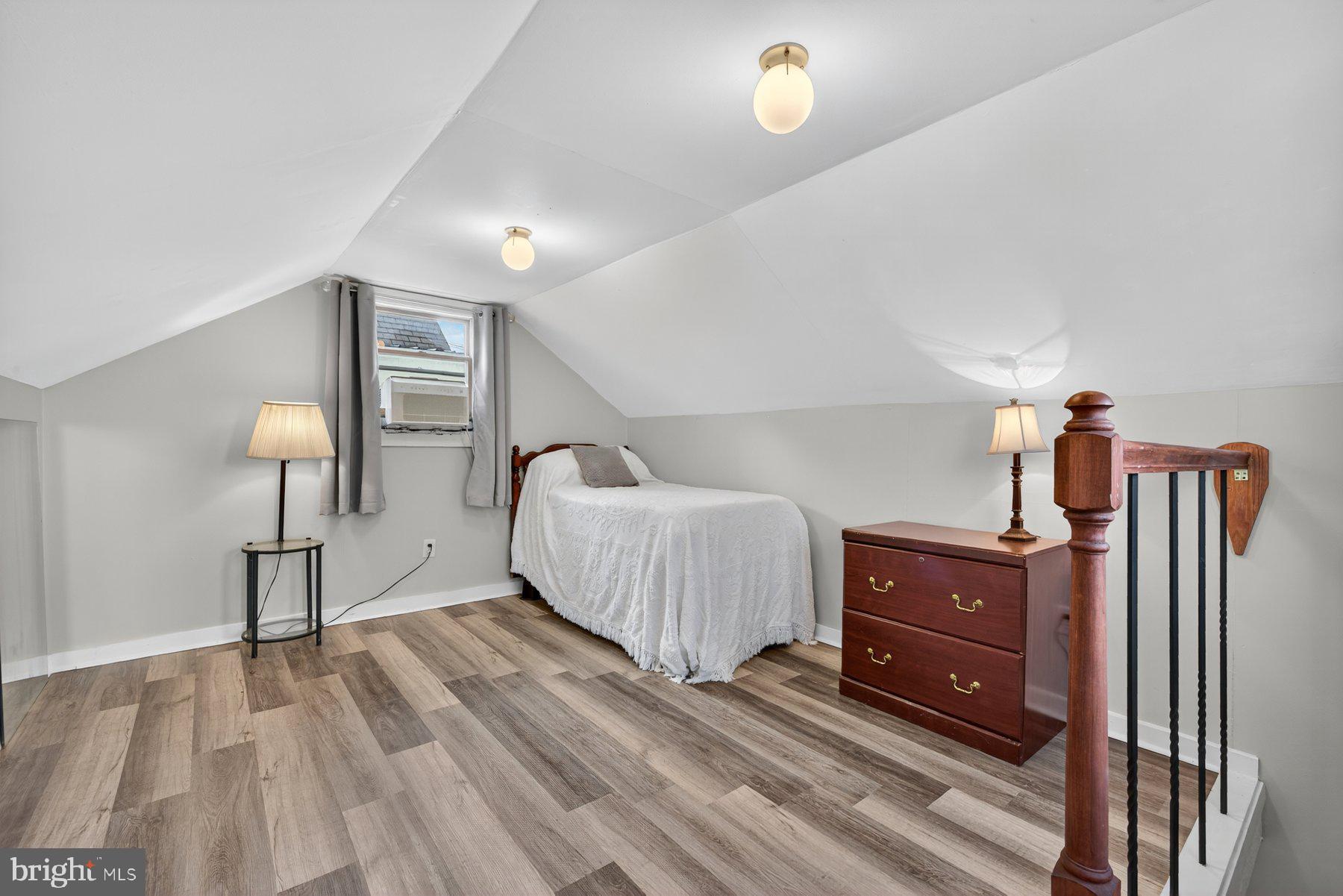 58 East Baltimore Street Taneytown, MD 21787 - Photo 44 of 56 a spacious bedroom with a bed and wooden floor