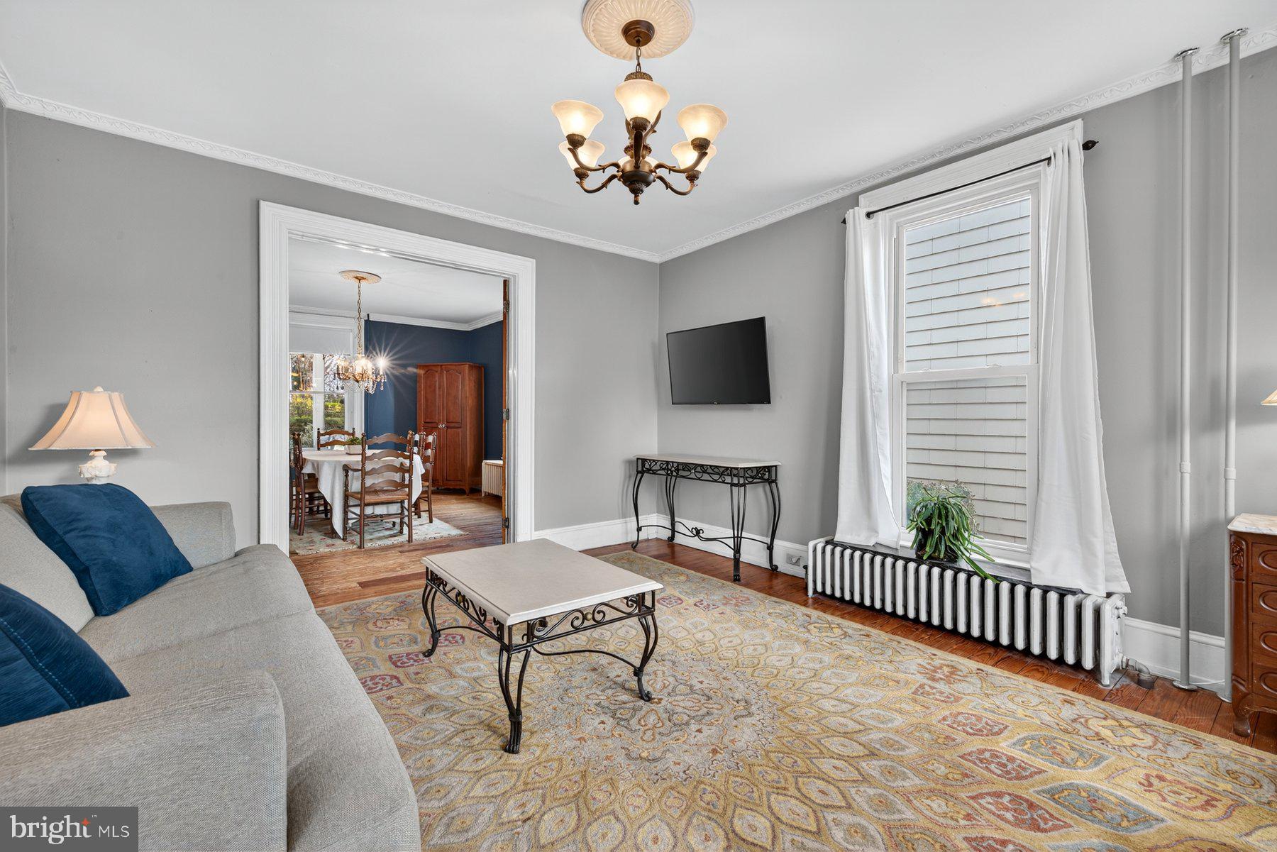 58 East Baltimore Street Taneytown, MD 21787 - Photo 6 of 56 a living room with furniture a chandelier and a window