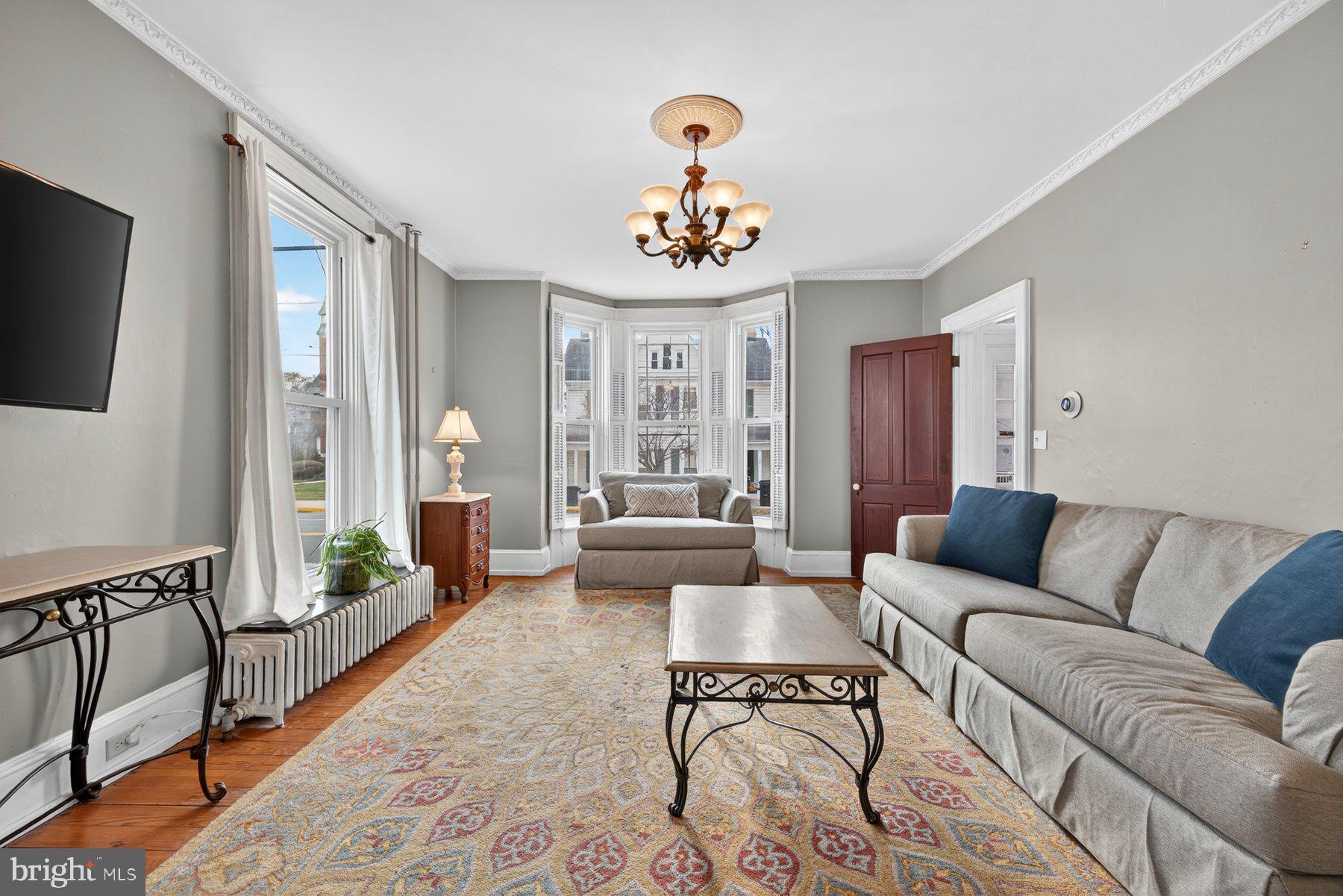 58 East Baltimore Street Taneytown, MD 21787 - Photo 7 of 56 a living room with furniture chandelier and a window