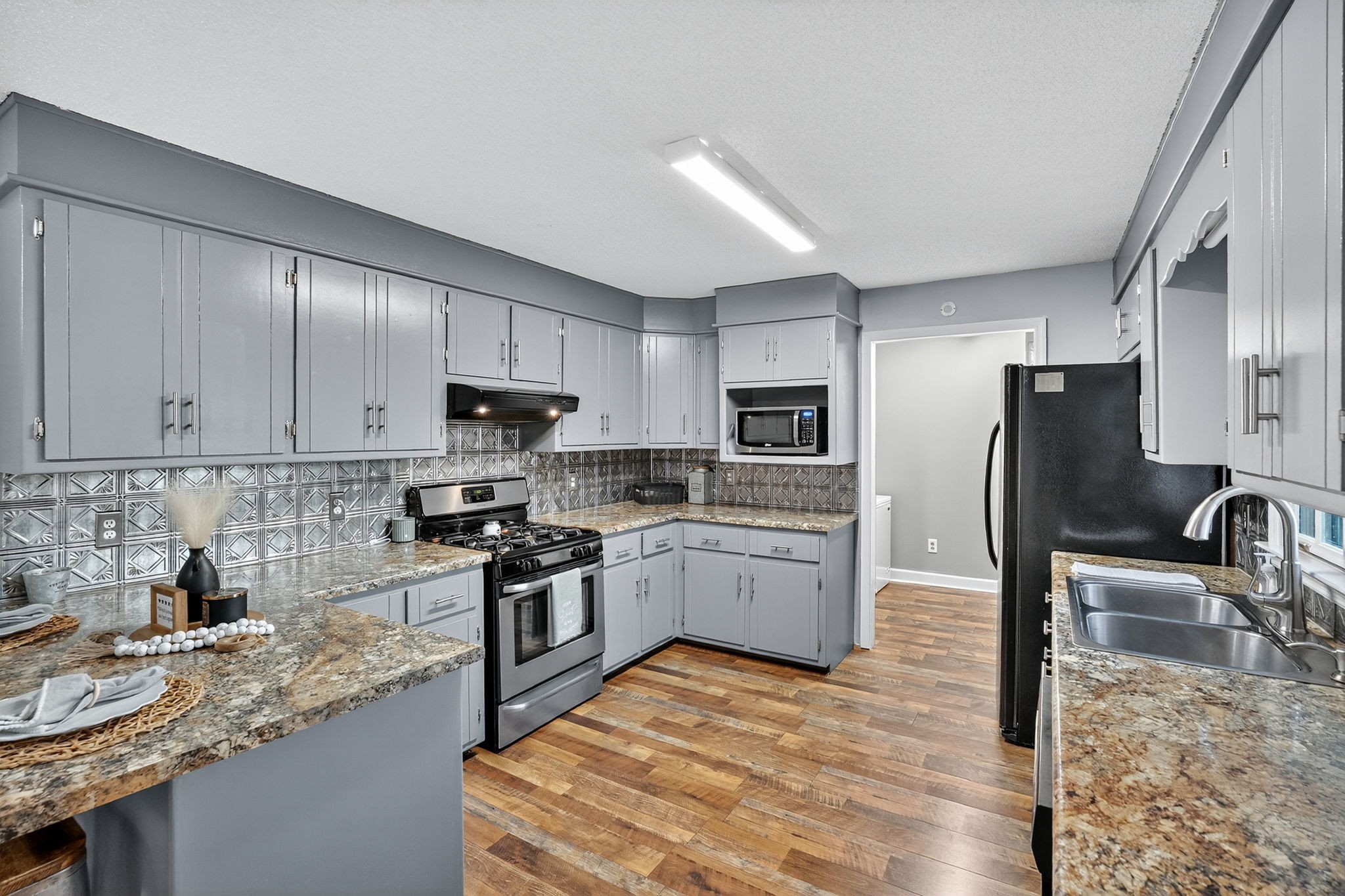 93 Jean Drive Tullahoma, TN 37388 - Photo 20 of 53 a kitchen with stainless steel appliances granite countertop a sink stove refrigerator and cabinets