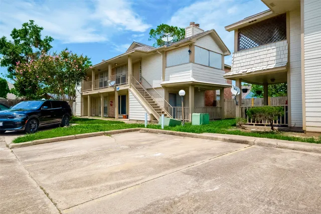 a front view of a house with a garden and plants