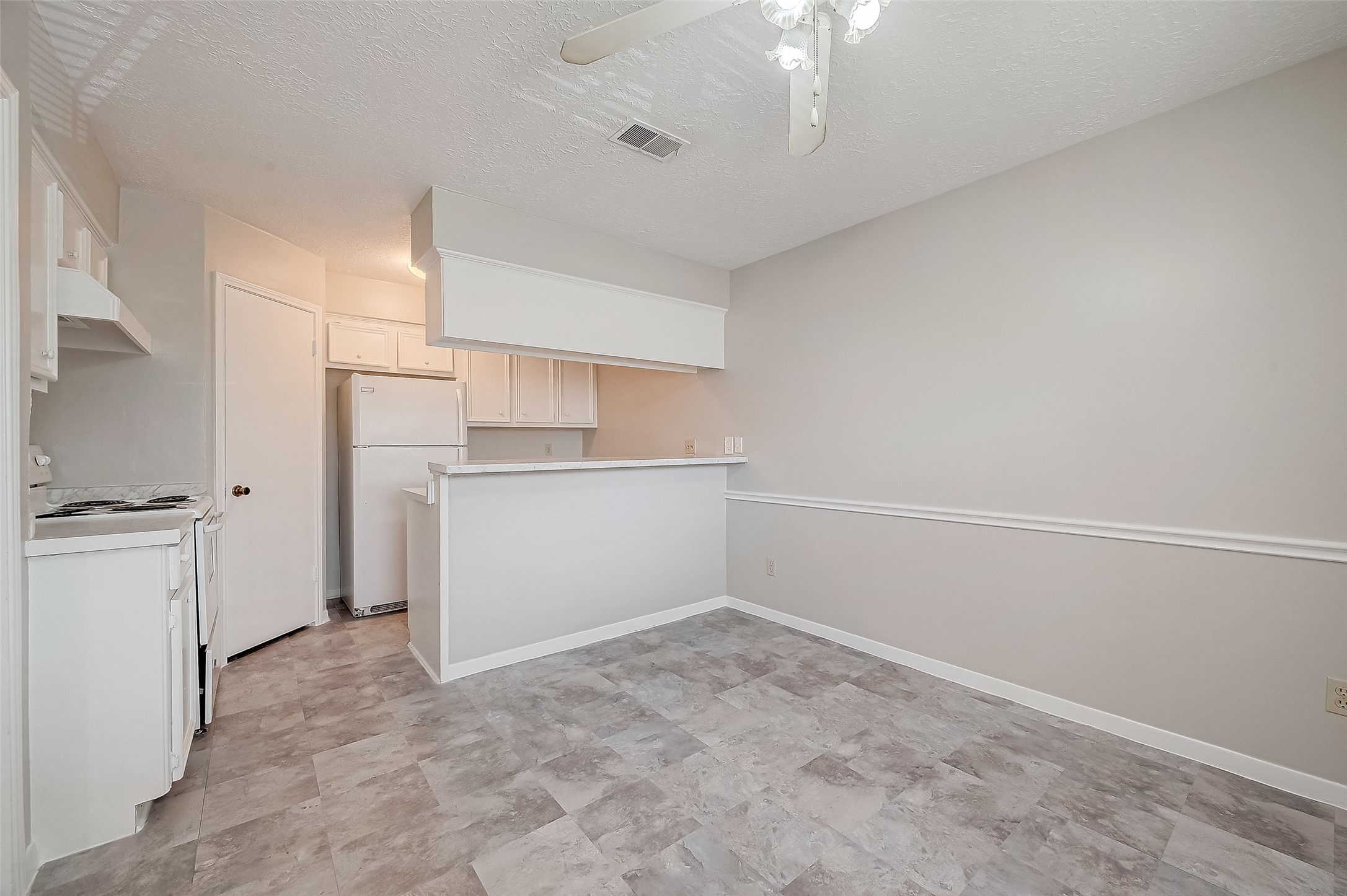11503 Meadow Lane, Unit D Houston, TX 77477 - Photo 15 of 39 a view of a kitchen with a sink and dishwasher a refrigerator with white cabinets