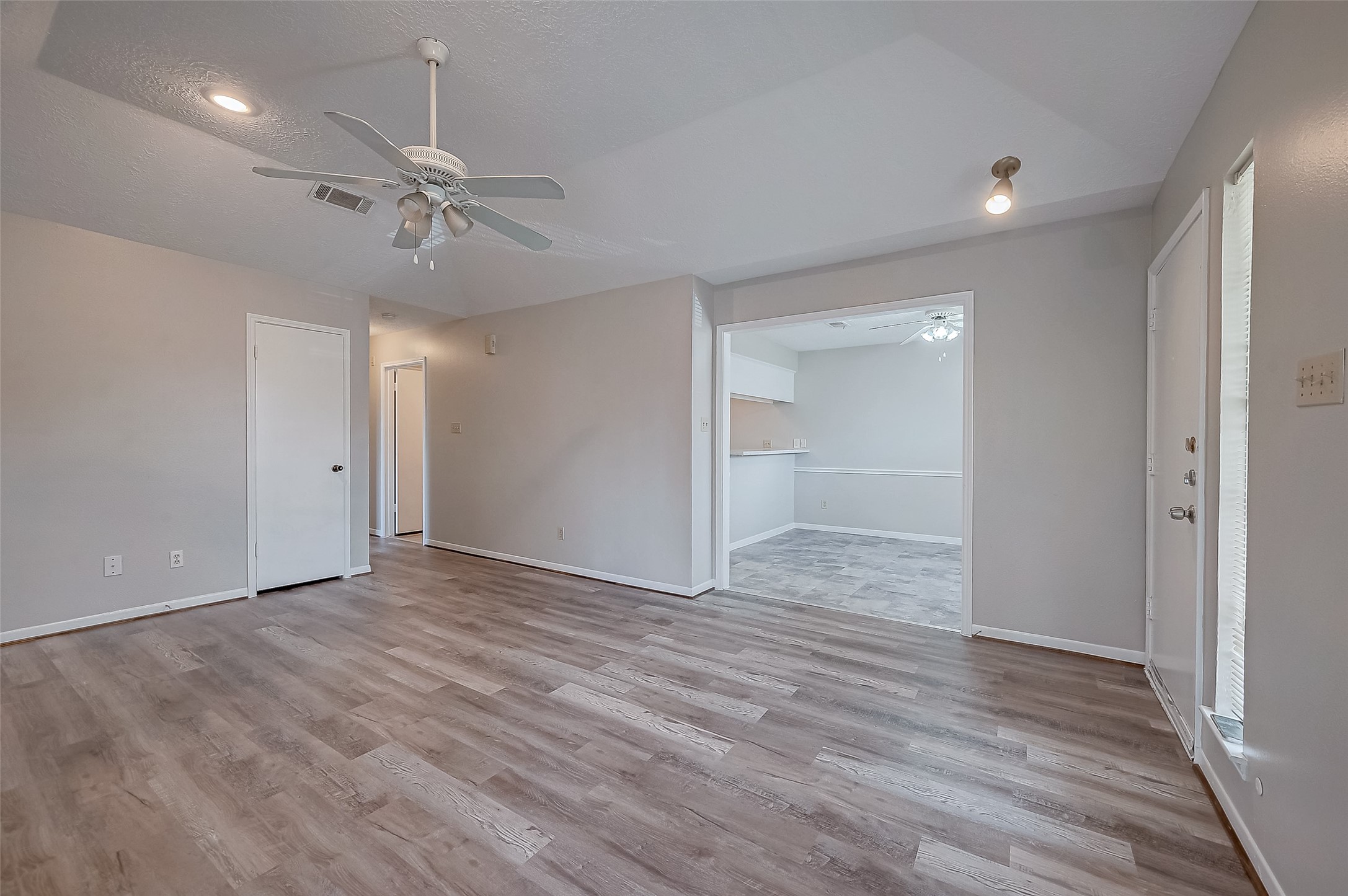 11503 Meadow Lane, Unit D Houston, TX 77477 - Photo 17 of 39 a view of an empty room with a chandelier fan