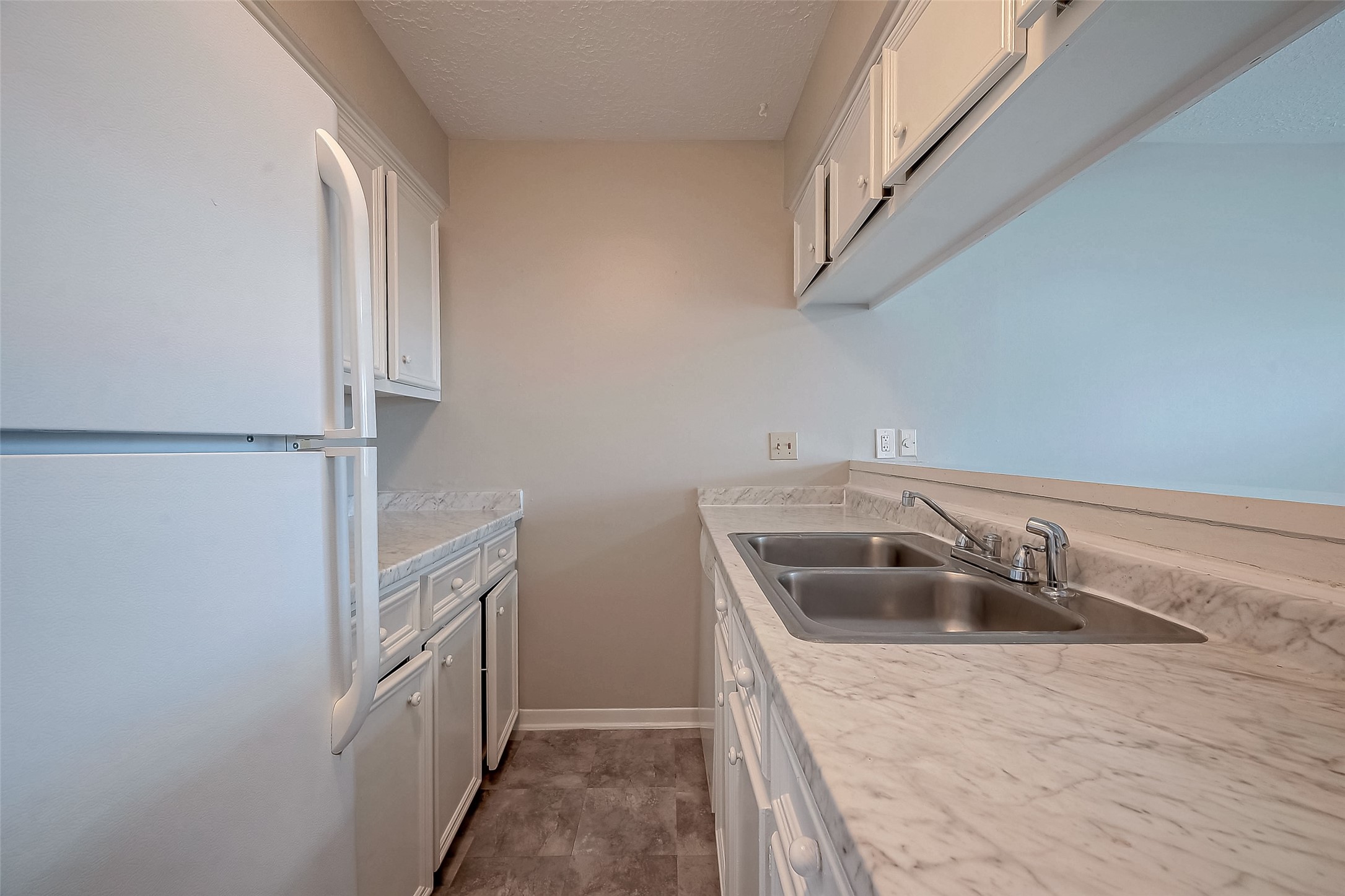 11503 Meadow Lane, Unit D Houston, TX 77477 - Photo 20 of 39 a kitchen with a sink and refrigerator