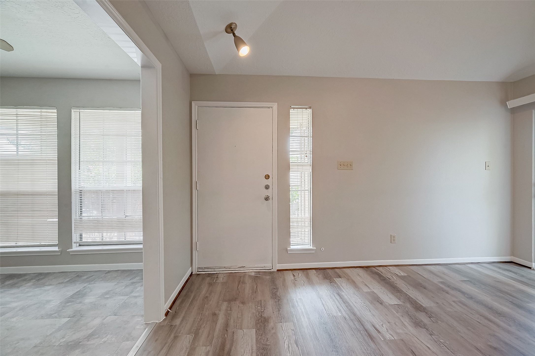 11503 Meadow Lane, Unit D Houston, TX 77477 - Photo 2 of 39 an empty room with wooden floor and windows