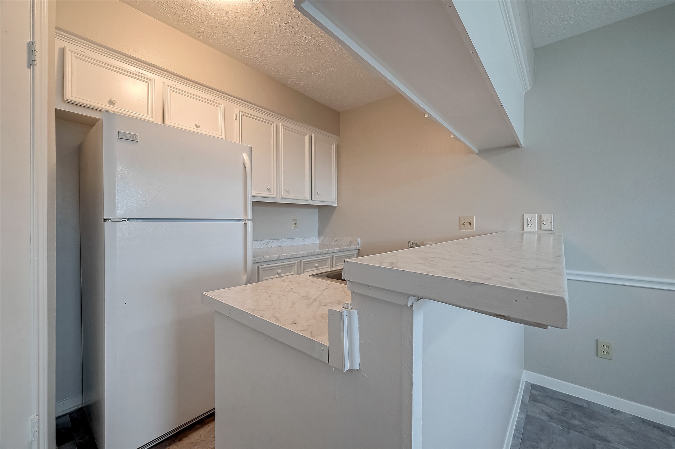 11503 Meadow Lane, Unit D Houston, TX 77477 - Photo 22 of 39 a kitchen with a refrigerator and a sink