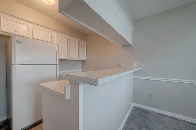 a view of storage and utility room with refrigerator