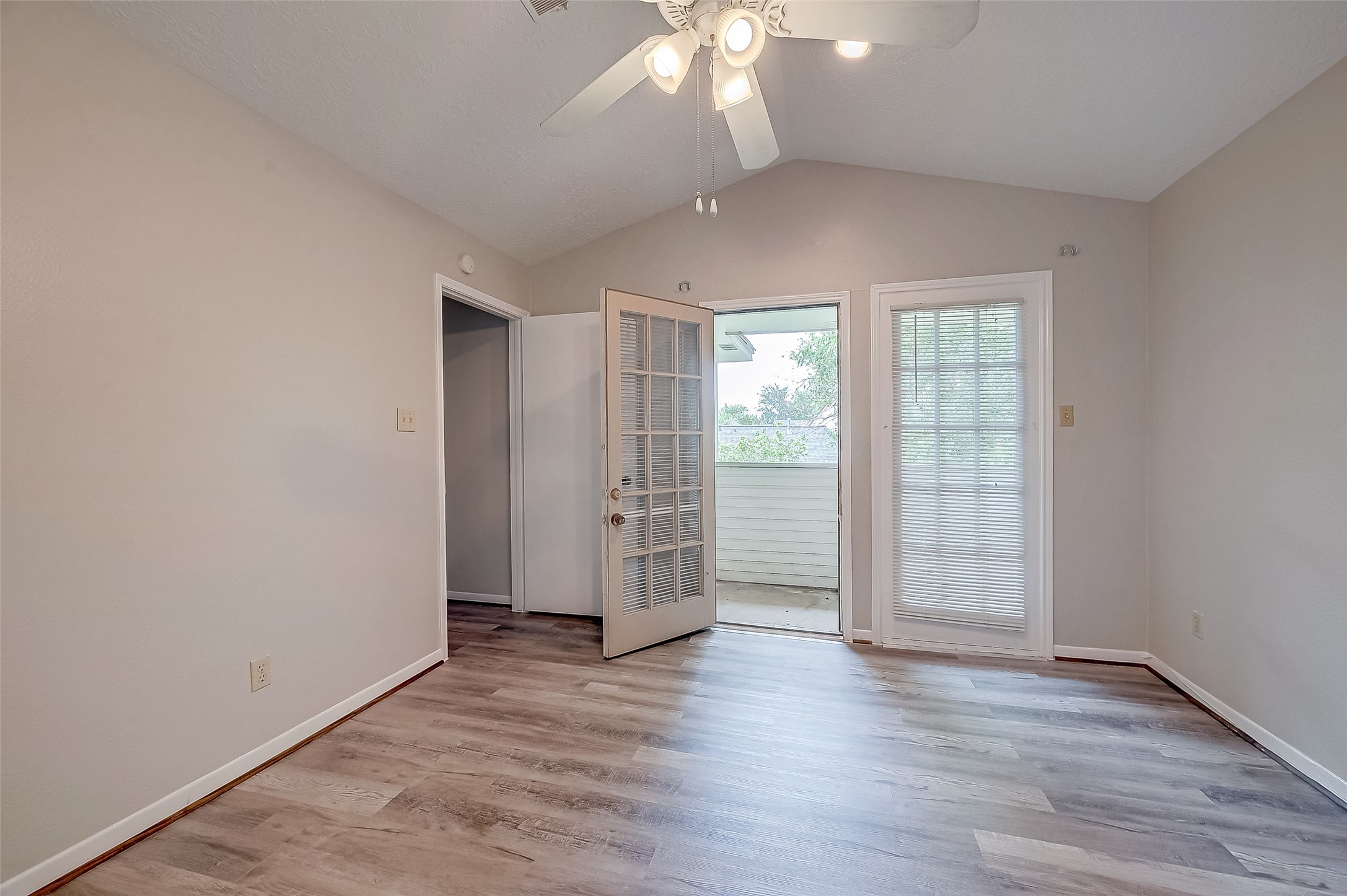 11503 Meadow Lane, Unit D Houston, TX 77477 - Photo 29 of 39 an empty room with wooden floor and windows