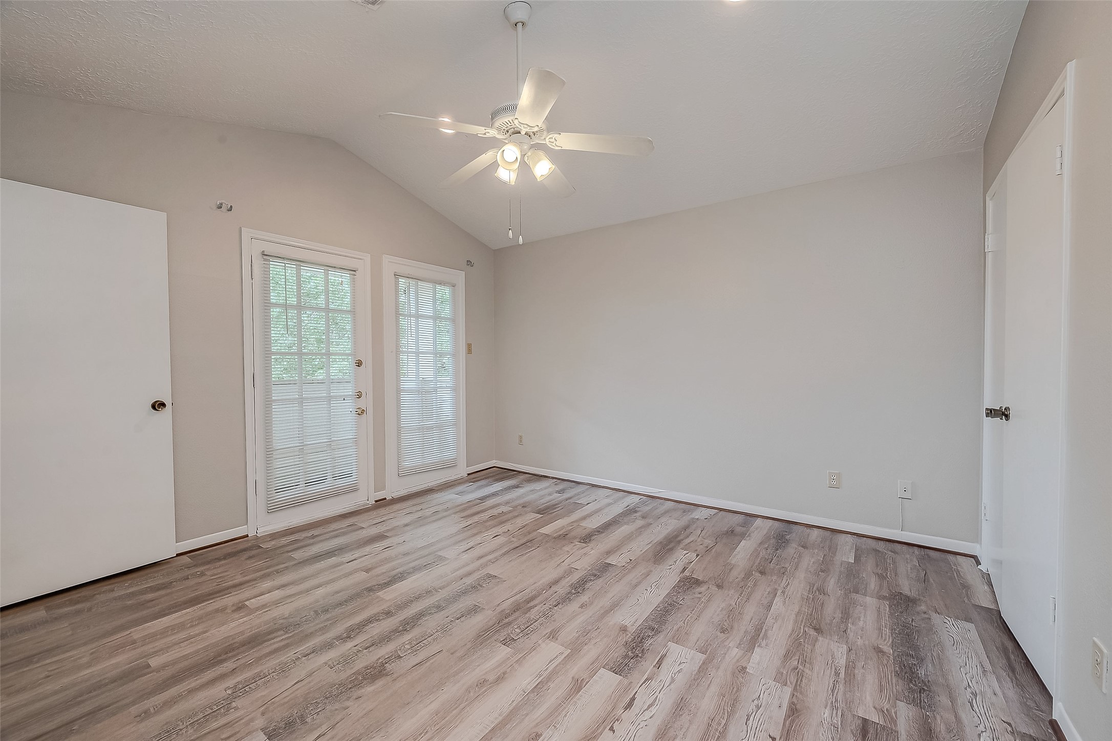 11503 Meadow Lane, Unit D Houston, TX 77477 - Photo 30 of 39 a view of an empty room with wooden floor and a window