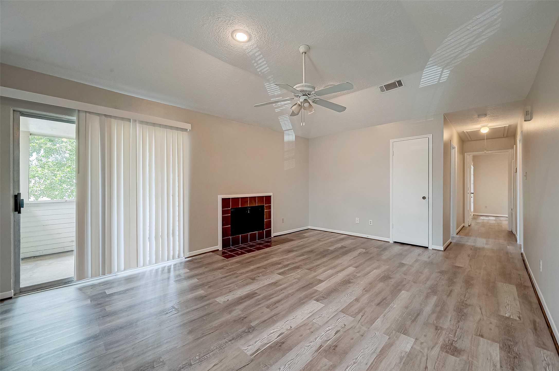 11503 Meadow Lane, Unit D Houston, TX 77477 - Photo 3 of 39 an empty room with wooden floor fan and windows