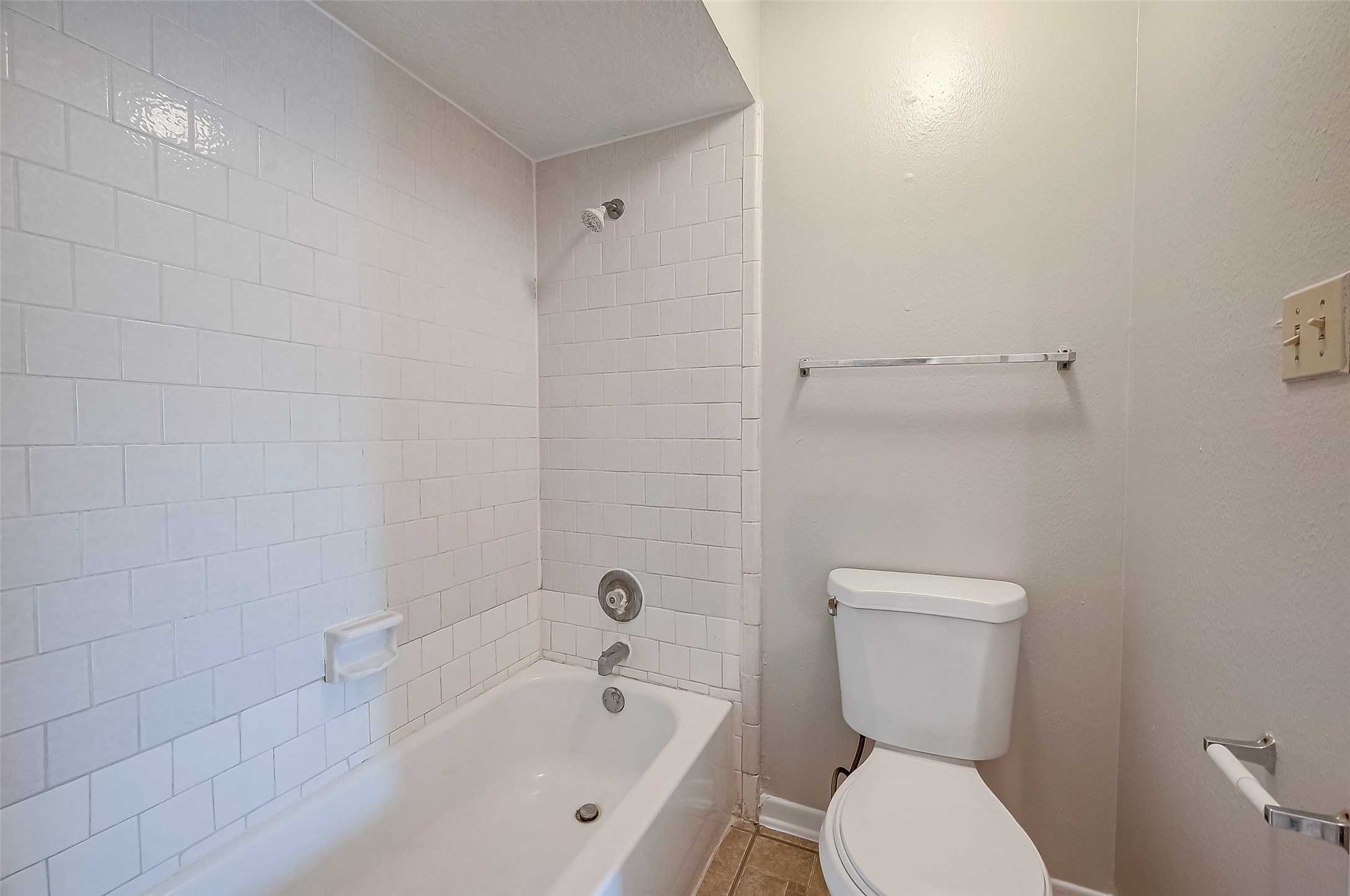 11503 Meadow Lane, Unit D Houston, TX 77477 - Photo 33 of 39 a white toilet sitting next to a bath tub