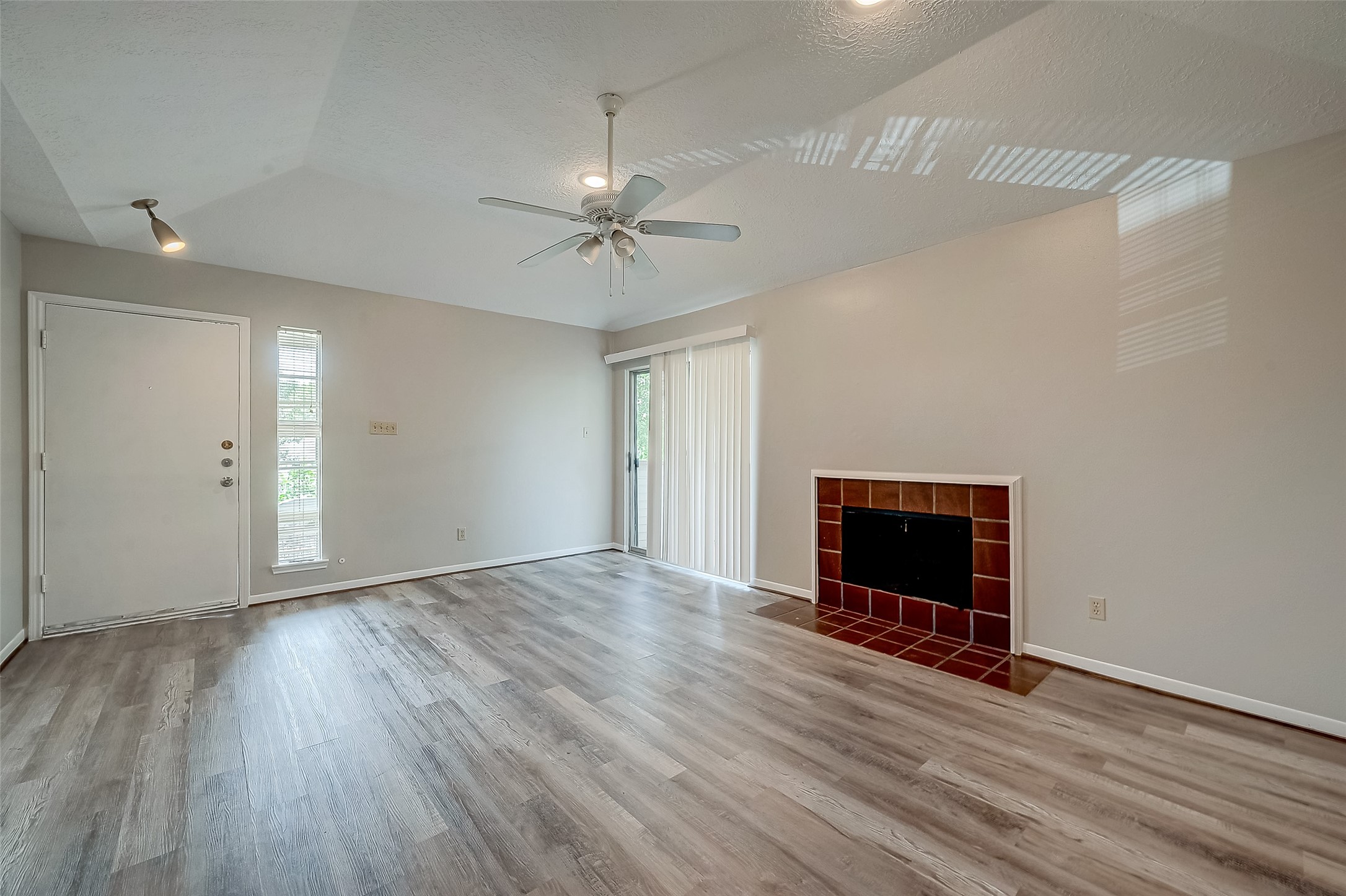11503 Meadow Lane, Unit D Houston, TX 77477 - Photo 4 of 39 wooden floor in an empty room with a fireplace