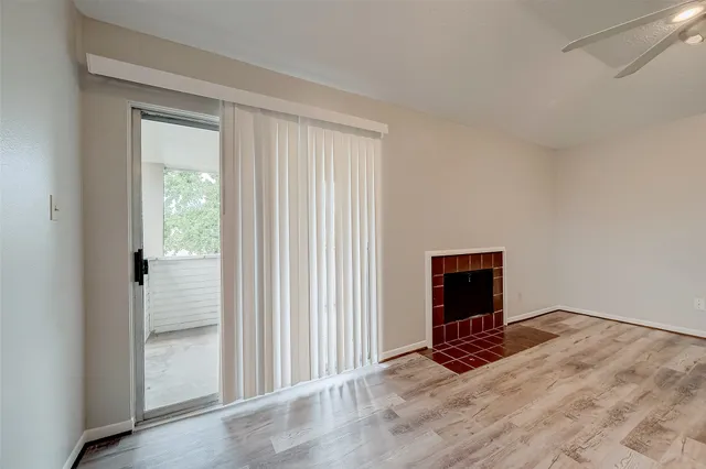 a view of a livingroom with wooden floor and a flat screen tv
