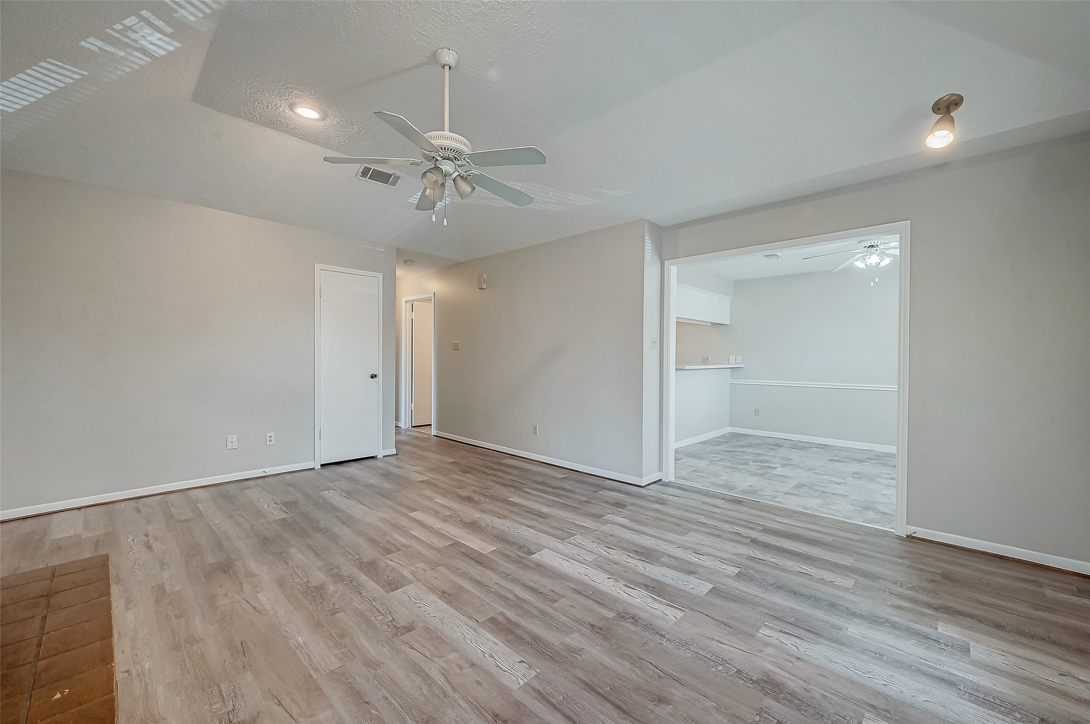 11503 Meadow Lane, Unit D Houston, TX 77477 - Photo 7 of 39 wooden floor in an empty room with a window