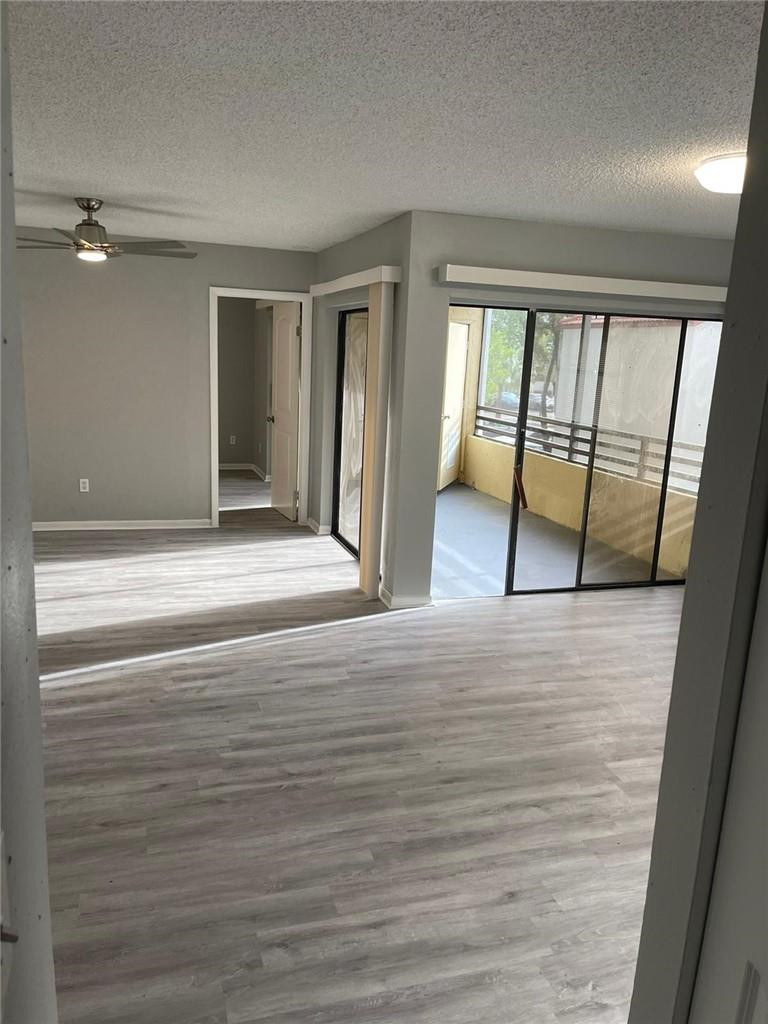 1112 North Hiatus Road, Unit 1112 Pembroke Pines, FL 33026 - Photo 15 of 48 wooden floor in an empty room with a window