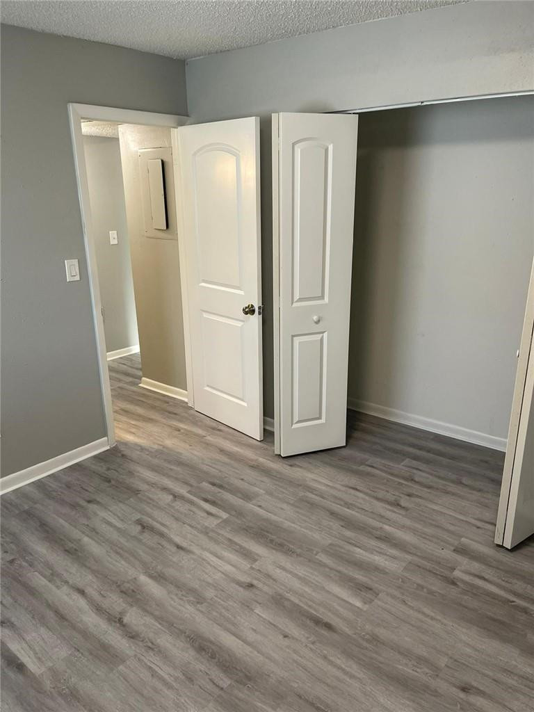1112 North Hiatus Road, Unit 1112 Pembroke Pines, FL 33026 - Photo 18 of 48 an empty room with wooden floor and entrance