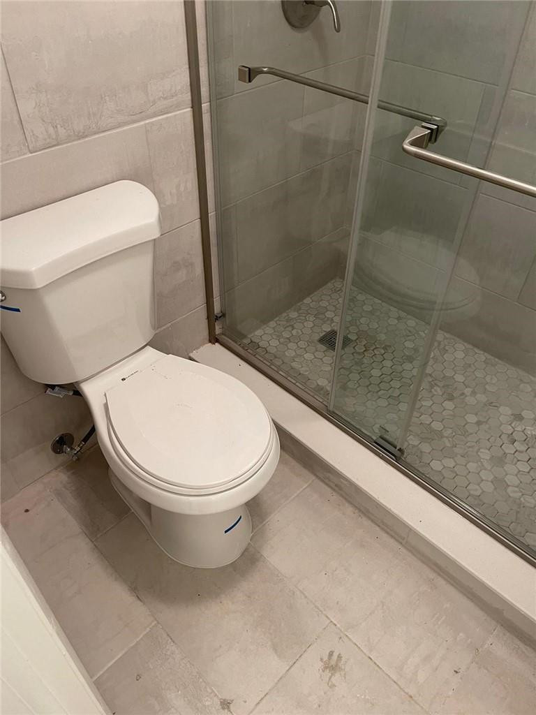 1112 North Hiatus Road, Unit 1112 Pembroke Pines, FL 33026 - Photo 26 of 48 a white toilet sitting next to a bath tub