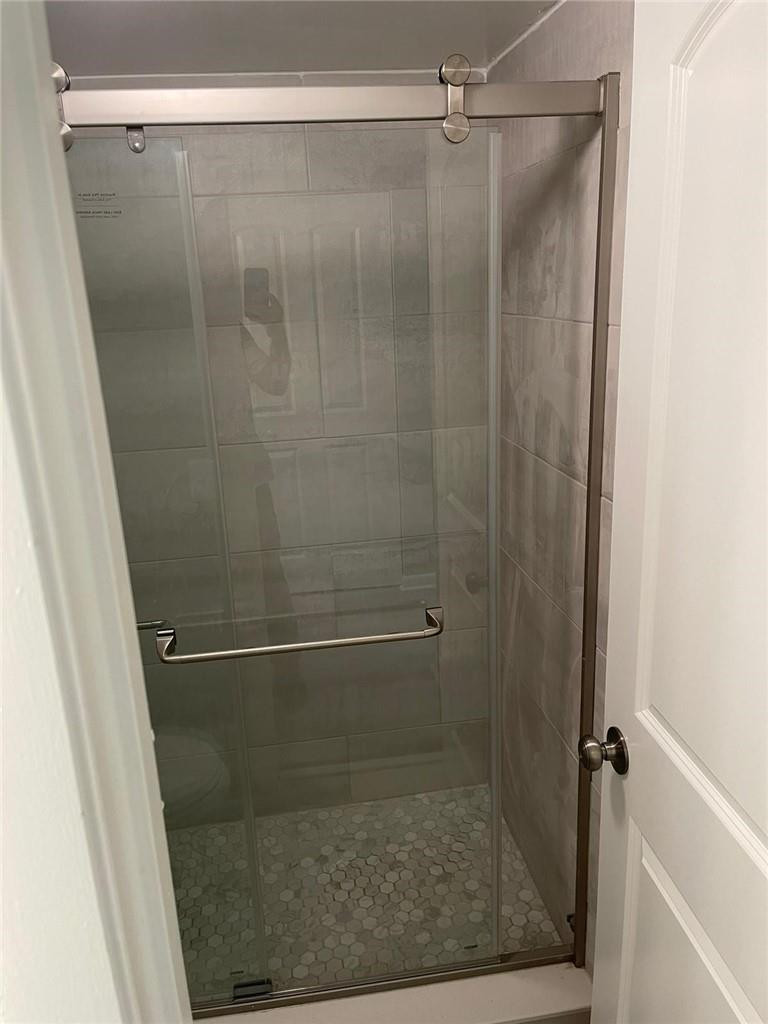 1112 North Hiatus Road, Unit 1112 Pembroke Pines, FL 33026 - Photo 28 of 48 a bathroom with a glass shower door