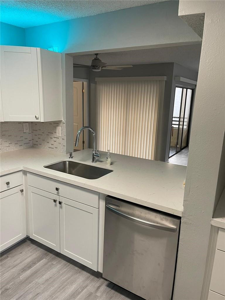 1112 North Hiatus Road, Unit 1112 Pembroke Pines, FL 33026 - Photo 3 of 48 a kitchen with white cabinets and sink
