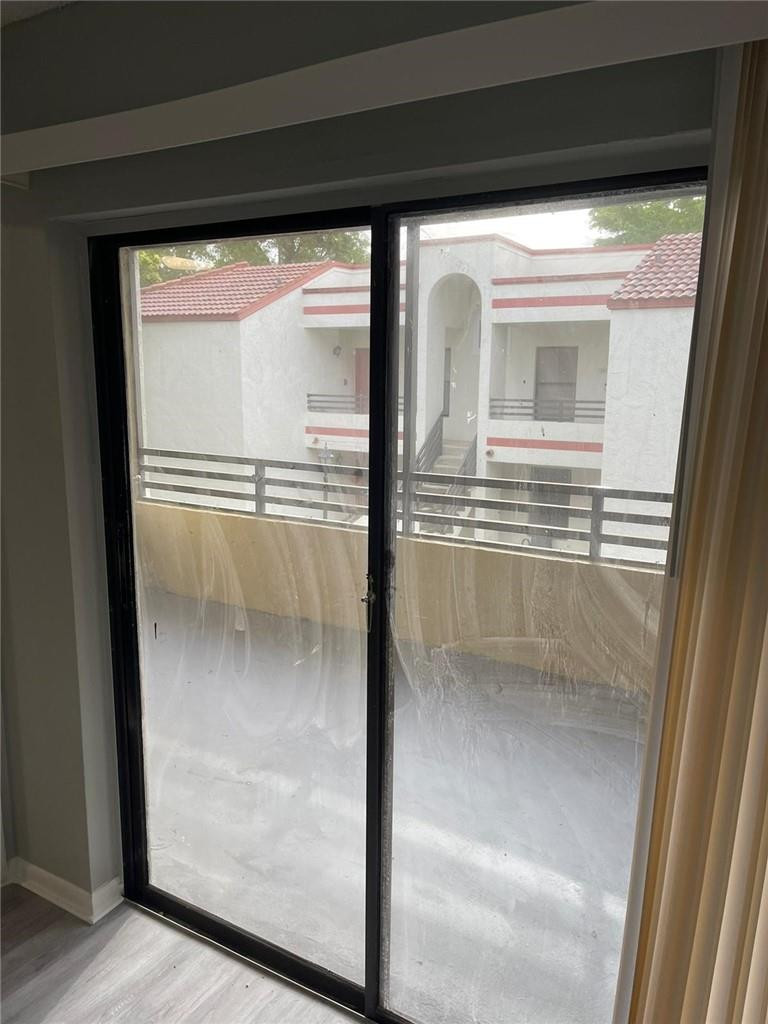 1112 North Hiatus Road, Unit 1112 Pembroke Pines, FL 33026 - Photo 31 of 48 a bathroom with a glass shower door