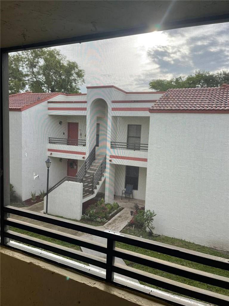 1112 North Hiatus Road, Unit 1112 Pembroke Pines, FL 33026 - Photo 33 of 48 a front view of a house with windows