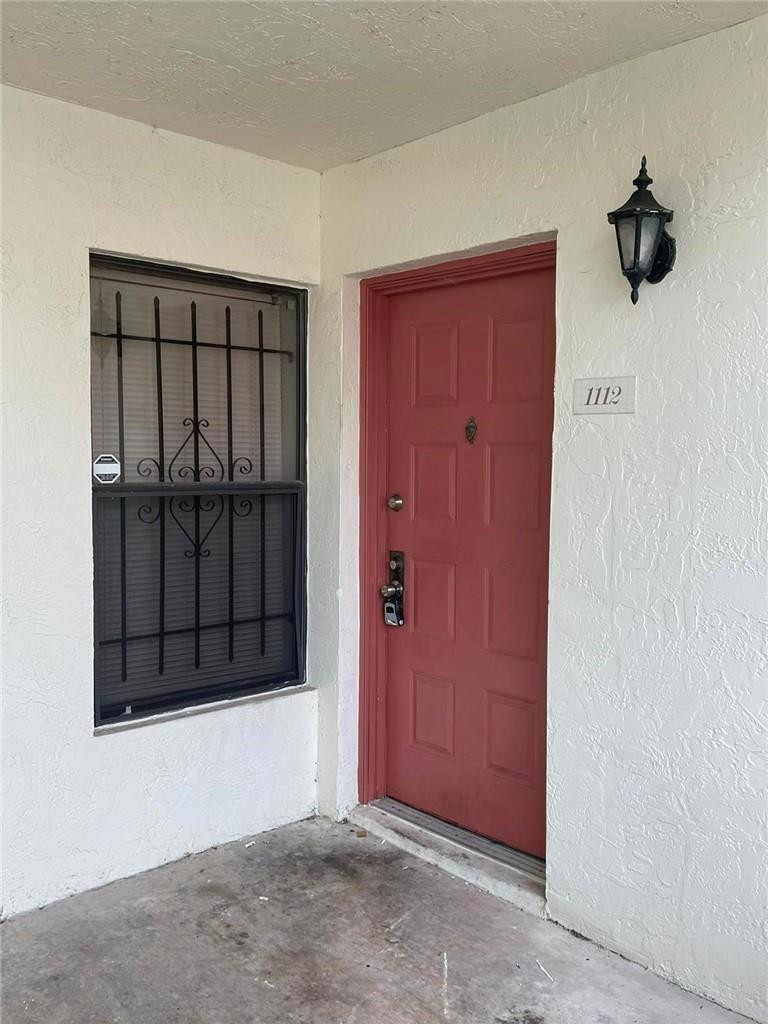 1112 North Hiatus Road, Unit 1112 Pembroke Pines, FL 33026 - Photo 37 of 48 a view of a livingroom with a door