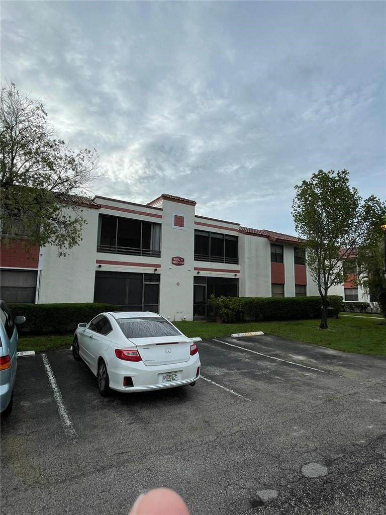 1112 North Hiatus Road, Unit 1112 Pembroke Pines, FL 33026 - Photo 39 of 48 a car parked in front of a house